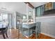 Eat-in kitchen area, complete with a bar, flows into dining area, stainless steel appliances, and hardwood floors at 1115 O T Wallace Blvd, Moncks Corner, SC 29461