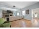 Spacious living room featuring a cozy brick fireplace, hardwood floors, and lots of natural light at 1115 O T Wallace Blvd, Moncks Corner, SC 29461