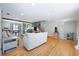 Open concept living room featuring hardwood floors, neutral paint, and a seamless connection to the kitchen at 1115 O T Wallace Blvd, Moncks Corner, SC 29461
