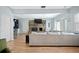 Open-concept living room with wood floors, a brick fireplace, and lots of natural light at 1115 O T Wallace Blvd, Moncks Corner, SC 29461