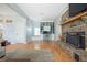 Inviting living room with a brick fireplace, wood floors, and a built-in desk area at 1115 O T Wallace Blvd, Moncks Corner, SC 29461