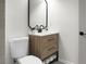 Bathroom featuring a wooden vanity, sleek black fixtures, and a built-in shelf for towels at 113 Harter Dr, Summerville, SC 29485
