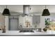Stylish kitchen island with a modern range hood and designer lighting at 113 Harter Dr, Summerville, SC 29485