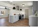 Open kitchen design with stainless steel range hood and modern light fixtures at 113 Harter Dr, Summerville, SC 29485