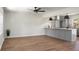 Open-concept living room showcasing hardwood floors and adjoined to a kitchen featuring a large center island at 113 Harter Dr, Summerville, SC 29485