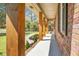 Covered porch featuring wooden columns, manicured landscaping, and a view of the front yard at 113 Harter Dr, Summerville, SC 29485