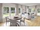 Bright and airy living room with large windows, hardwood floors, and comfortable seating arrangement at 114 Moscato Ln, Summerville, SC 29485