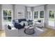 Cozy living room with a blue sofa, stylish decor, large windows and lots of natural light at 114 Moscato Ln, Summerville, SC 29485