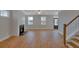 Spacious living room with fireplace, hardwood floors, stairs, and plenty of natural light at 121 Cantona Dr, Summerville, SC 29483