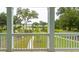 Scenic balcony view showcasing the lush landscaping and tranquil pond surroundings at 126 Cantona Dr, Summerville, SC 29483