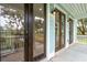 Close-up of a front porch with wooden and glass doors and modern light fixtures at 126 Cantona Dr, Summerville, SC 29483