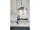A close-up of the modern kitchen with stainless steel appliances, white backsplash and dark hardware at 126 Cantona Dr, Summerville, SC 29483