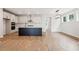 A modern kitchen boasts stainless steel appliances, a large island with a dark finish, and light wood flooring at 126 Cantona Dr, Summerville, SC 29483