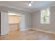 Bedroom with gray walls, ceiling fan, window with wooded view, and walk-in closet at 1329 Wood Sorrel Dr, Moncks Corner, SC 29461