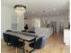 Open-concept dining room leading into the kitchen with a modern chandelier and seating at 1329 Wood Sorrel Dr, Moncks Corner, SC 29461