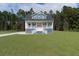 Charming home featuring a spacious porch, two stories, and a beautifully landscaped yard at 1329 Wood Sorrel Dr, Moncks Corner, SC 29461