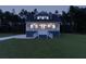 Charming two-story home with a covered front porch, white railings, and well-manicured lawn at dusk at 1329 Wood Sorrel Dr, Moncks Corner, SC 29461
