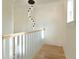 Hallway with a decorative light fixture, wood floors, and bright white trim at 1329 Wood Sorrel Dr, Moncks Corner, SC 29461