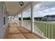 Inviting porch with wood floors and bright lighting, perfect for relaxing and enjoying the outdoors at 1329 Wood Sorrel Dr, Moncks Corner, SC 29461