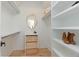 Organized walk-in closet with built-in shelving and wooden drawers at 1329 Wood Sorrel Dr, Moncks Corner, SC 29461