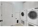 Laundry room with white washer and dryer on risers and white cabinetry at 1357 Osmond Rd, Mount Pleasant, SC 29466