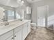 Bathroom with double sink vanity, white cabinets, and a large mirror at 139 Gazania Way, Charleston, SC 29414