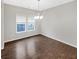 Bright dining room with wood floors, chandelier, and two windows at 139 Gazania Way, Charleston, SC 29414