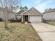 Charming one-story home features a well-maintained lawn and a two-car garage at 139 Gazania Way, Charleston, SC 29414