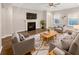Comfortable living room featuring a fireplace, ceiling fan and neutral colored walls at 139 Gazania Way, Charleston, SC 29414
