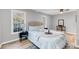 Bright bedroom with two windows, ceiling fan, and hardwood floors at 1393 Secessionville Rd, James Island, SC 29412