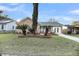 Charming brick home with manicured lawn, beautiful landscaping, and a light blue door at 1393 Secessionville Rd, James Island, SC 29412