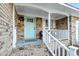 Inviting front porch with a wreath hanging on the light blue front door and brick flooring at 1393 Secessionville Rd, James Island, SC 29412