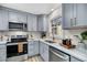 This stunning kitchen features light grey cabinets, stainless steel appliances, and white countertops at 1393 Secessionville Rd, James Island, SC 29412