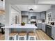 Stylish kitchen with an island that has bar stool seating, light grey cabinets, and stainless appliances at 1393 Secessionville Rd, James Island, SC 29412