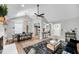 Open concept living room with vaulted ceilings, fireplace, and dining area adjacent to modern kitchen at 1393 Secessionville Rd, James Island, SC 29412