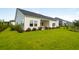 Expansive backyard with lush green lawn, mature trees, and a cozy patio perfect for outdoor entertaining and relaxation at 141 Threaded Fern St, Summerville, SC 29485