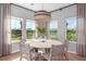 Charming dining area with large windows offering scenic views and a decorative light fixture at 141 Threaded Fern St, Summerville, SC 29485