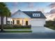 Charming single-Gathering home with a welcoming front porch and a well-maintained lawn with beautiful landscaping at 141 Threaded Fern St, Summerville, SC 29485