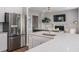 Bright kitchen featuring stainless steel appliances, quartz countertops, and an open view into the living area at 141 Threaded Fern St, Summerville, SC 29485