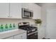 Stylish kitchen featuring stainless steel appliances, white cabinetry, and a subway tile backsplash at 141 Threaded Fern St, Summerville, SC 29485