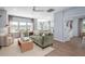 Comfortable living room with large windows, modern furniture, and an open layout into other rooms at 141 Threaded Fern St, Summerville, SC 29485