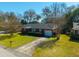 Aerial shot of a well-kept brick home boasting a driveway and a lush green lawn at 1423 Fairfield Ave, Charleston, SC 29407