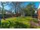 Large backyard with mature trees, a playset, and a storage shed at 1423 Fairfield Ave, Charleston, SC 29407