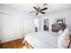 Bedroom with white bedding, hardwood floors, ceiling fan and a glimpse into an ensuite at 1423 Fairfield Ave, Charleston, SC 29407