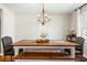 Charming dining area featuring a wooden table, bench seating, and a stylish chandelier at 1423 Fairfield Ave, Charleston, SC 29407