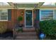 Inviting front door with green wreath, potted plants, and classic brick facade at 1423 Fairfield Ave, Charleston, SC 29407