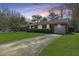 Charming brick home featuring a well-manicured lawn, a long driveway, and an attached garage at 1423 Fairfield Ave, Charleston, SC 29407