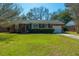 Charming brick home featuring a well-manicured lawn and classic architectural details at 1423 Fairfield Ave, Charleston, SC 29407