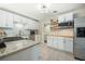 Updated kitchen featuring white cabinets, modern appliances, granite countertops, and stylish backsplash at 1423 Fairfield Ave, Charleston, SC 29407
