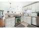 Well-lit kitchen features stainless steel appliances, granite countertops and white cabinets at 1423 Fairfield Ave, Charleston, SC 29407